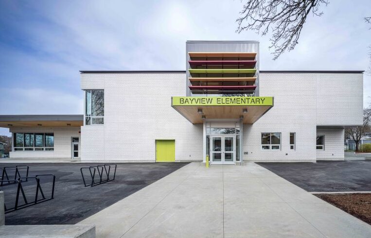 This exterior photo of Bayview Elementary School shows an entrance with cross laminated timber.