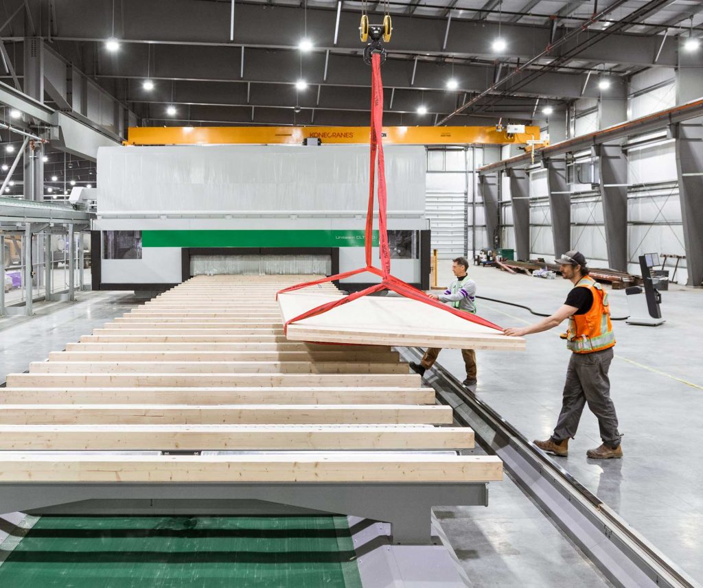mass timber engineered glulam panel being placed on production line