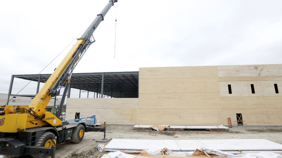 Our mass timber panels are going up at a warehouse construction site.